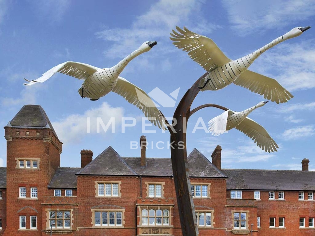 Bird statue in front of restoration of former hospital into development of large homes