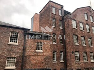 Restorative infills in the exterior brickwork of Grade II* listed Quarry Bank Mill, using a bespoke blend of Reclamation Red handmade bricks.