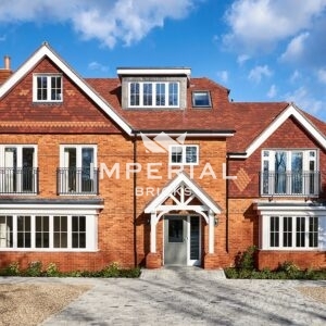 Front of large new build luxury apartment block, built using Farmhouse Orange handmade bricks.