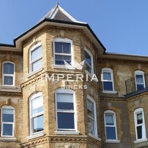 Top 2 storeys of a restored apartment building after it's collapse, featuring Reclamation Cambridge Buff bricks and specials.