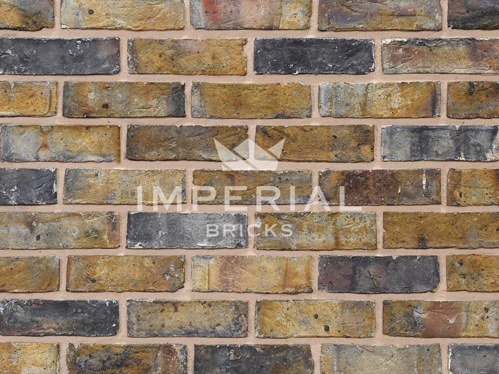 Dark Weathered Original London Stock bricks shown in a wall. The bricks have tonal weathering.