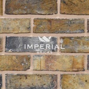 Dark Weathered Original London Stock bricks shown in a wall. Image is taken close up to show texture and detail in the brickwork.