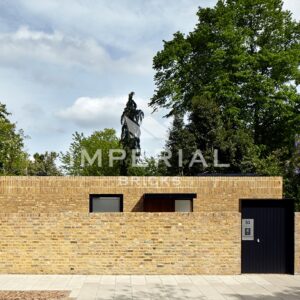 Residential single storey home with a boundary wall, the wall is built using Reclamation Yellow Stock bricks.