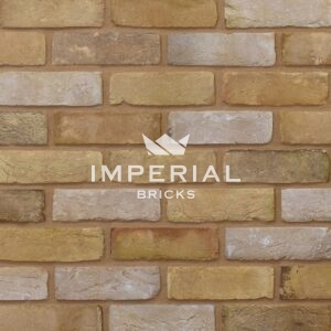 Reclamation Buff handmade bricks shown in a wall. The bricks a a creamy buff colour with a blend of whitewashed and lightly weathered faces.