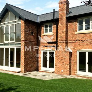 Rear of a large new build house built using reclamation red handmade bricks.