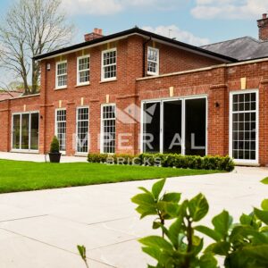 Angled view of a large wrap around home extension, built using Soft Red handmade bricks.