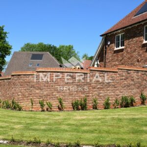 Garden wall surrounding a residential new build home, built using Tumbled Reclamation Red handmade bricks.