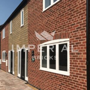 Close up angled view of a development of terraced residential homes, built using Urban Weathered handmade bricks.