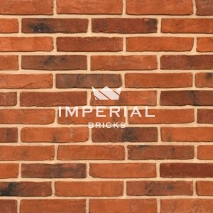 Tudor Multi handmade bricks shown in a wall. The bricks are orange blended with red and brown weathered shades.