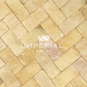 Suffolk Floor handmade paving bricks laid in the ground. The paving bricks are a buff yellow colour with some pale pink and grey tones.