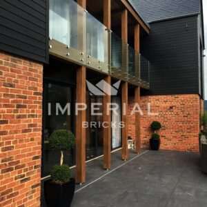 Large self build home built using Country Blend handmade bricks. Image is angled across the front entrance of the property.