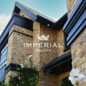 Upwards view of a grand residential new build home, with black windows and lintels.