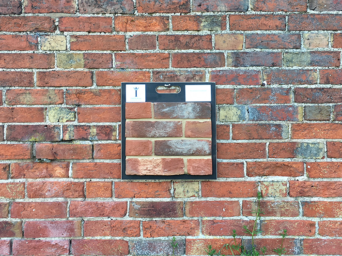 Brick board placed on an external wall to show a brick match.