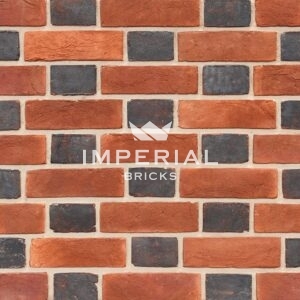 Blue header and soft red handmade bricks shown in a wall. The blue headers have a soft creased texture and are blue-grey in appearance.