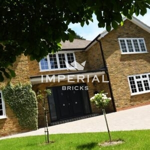 Side angle of a large residential home built using reclamation yellow multi stock bricks