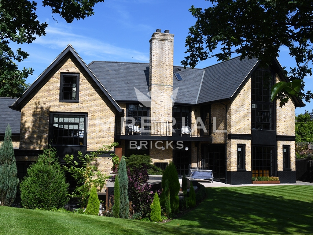 Residential self-build with dark features, built using Reclamation Yellow Stock handmade bricks.