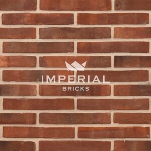 Linear 112 handmade bricks shown in a wall. The bricks are multi shades of red with dark overburns, and fine creasing on the faces.