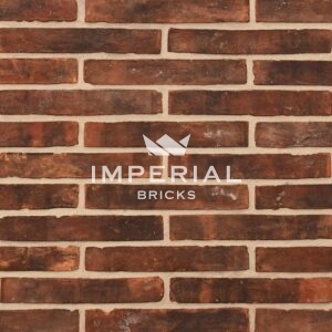 Linear 113 handmade bricks shown in a wall. The bricks are red with a sooted weathered finish and some minor traces of mortar on the faces.