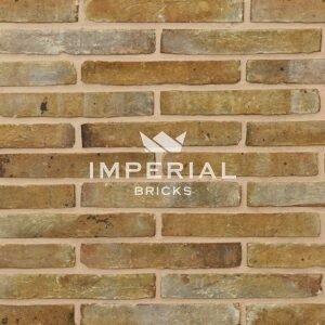Linear 131 handmade bricks shown in a wall. The bricks are mustard yellow with some shade variations, coal spotting and tonal weathering on the faces.