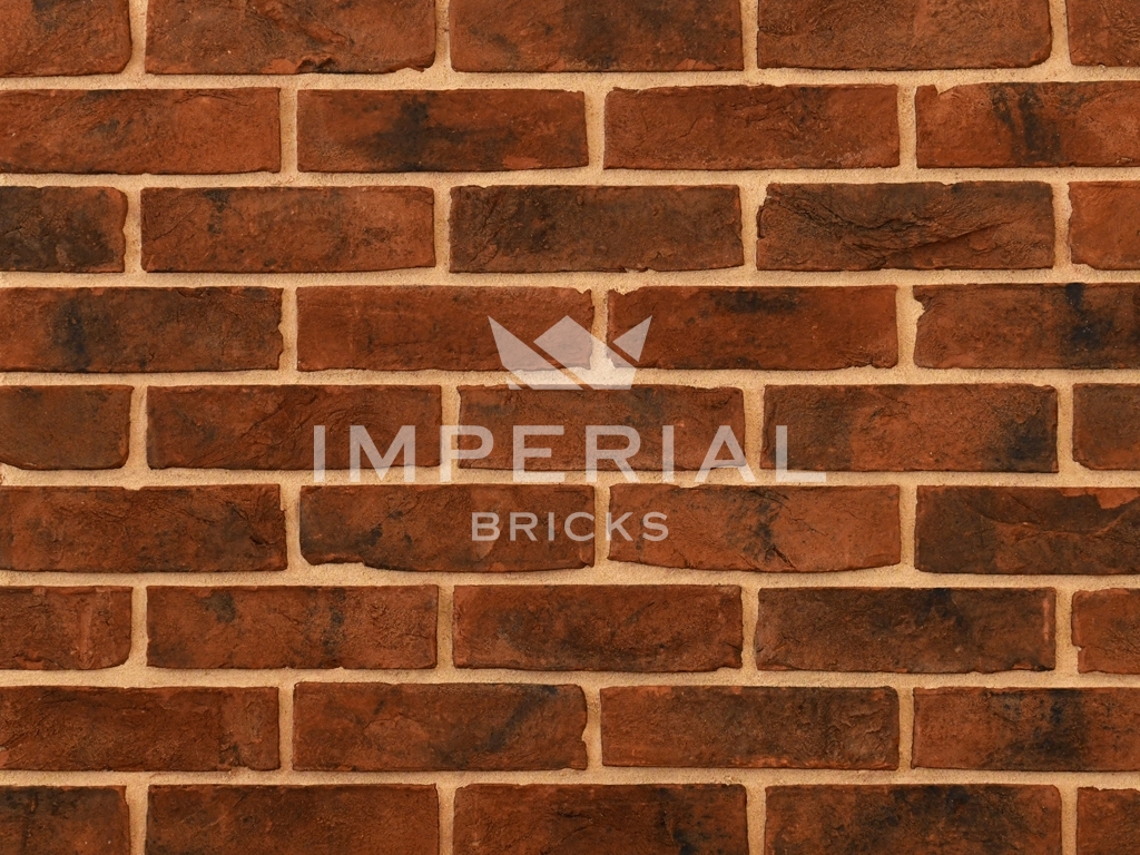 Urban Weathered bricks shown in a wall. The bricks have a red base colour with a sooted and dark weathered finish.