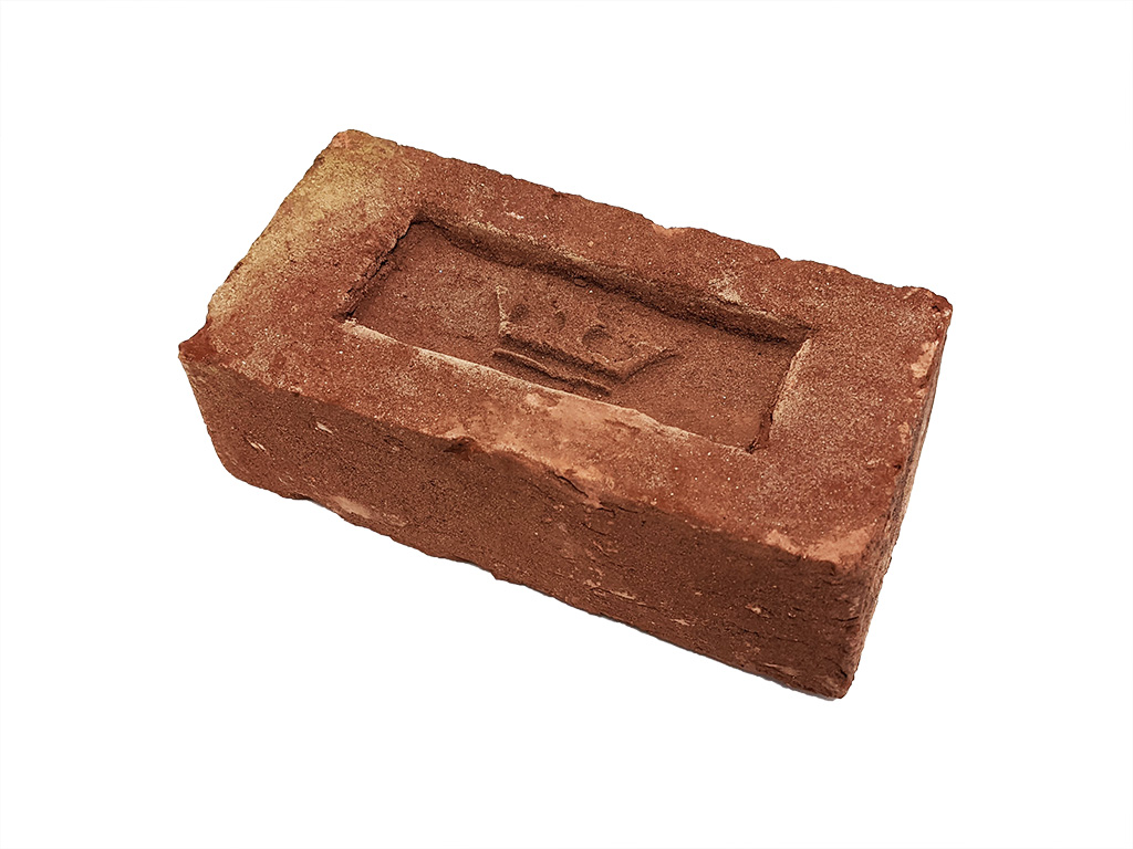 Red handmade brick with Imperial Bricks' crown logo stamped into the frog indentation.