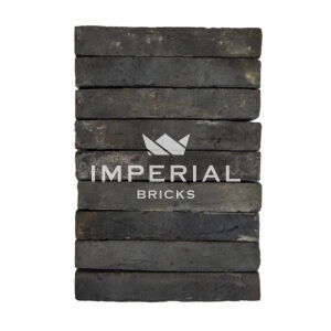 Bamburgh Black elongated bricks shown in a wall, the bricks are a mix of black and blue and feature banding on the faces.