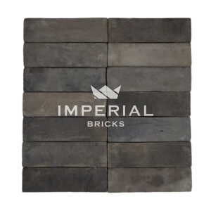 Bamburgh Black bricks shown in a wall, the bricks are a mix of black and blue and feature banding on the faces.