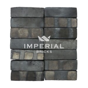 Bamburgh Black Multi bricks shown in a wall. The bricks are a mix between black and blue shades and have banding on the faces.