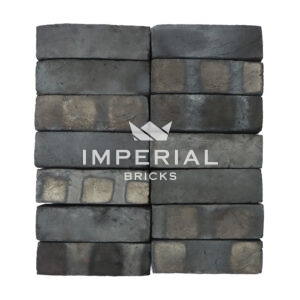 Bamburgh Black Multi bricks shown in a wall. The bricks are a mix between black and blue shades and have banding on the faces.