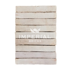 Kentwell White elongated bricks shown in a wall, are chalky soft white shade with pink and cream undertones.