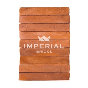 Milton Orange Multi handmade elongated bricks shown in a wall. The bricks are a soft orange and red shades.