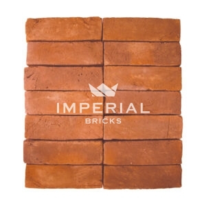 Milton Orange Multi handmade bricks shown in a wall. The bricks are a soft orange and red shades.