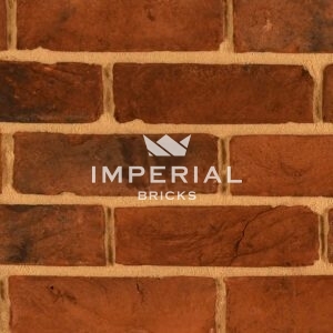 Urban Weathered Multi handmade bricks shown in a wall in detail. The bricks feature a red shade with plain and weathered faces.