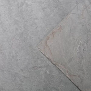 Windermere roof slate shown on a roof. The slate is green/grey shade with riven texture.