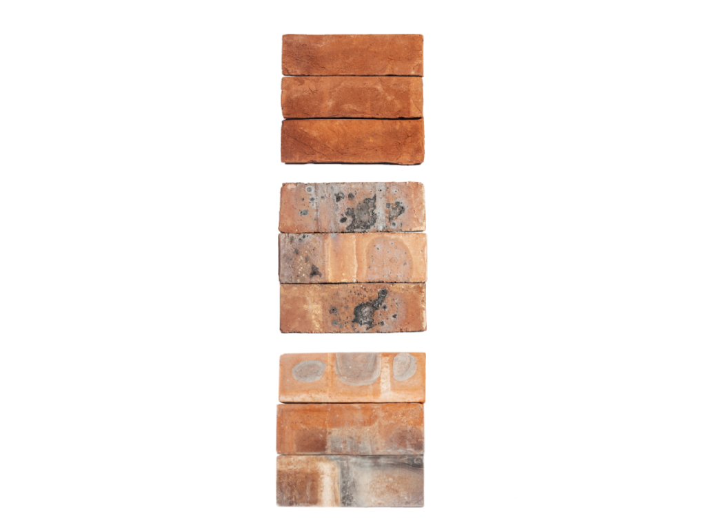 Three sets of three stacks of facing bricks.
