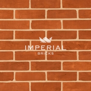 Orange Rubber bricks shown in a wall. The bricks have subtle texture and creasing on the faces.