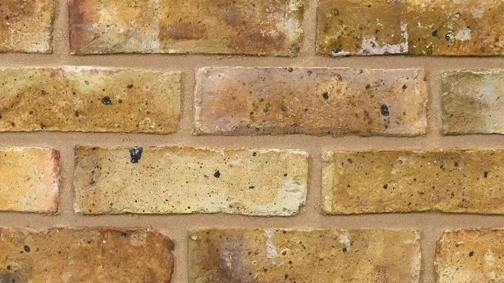 Traditional yellow London stock bricks, The bricks have a handmade, creased texture, natural shade variations, overburns and coal-spotted faces.